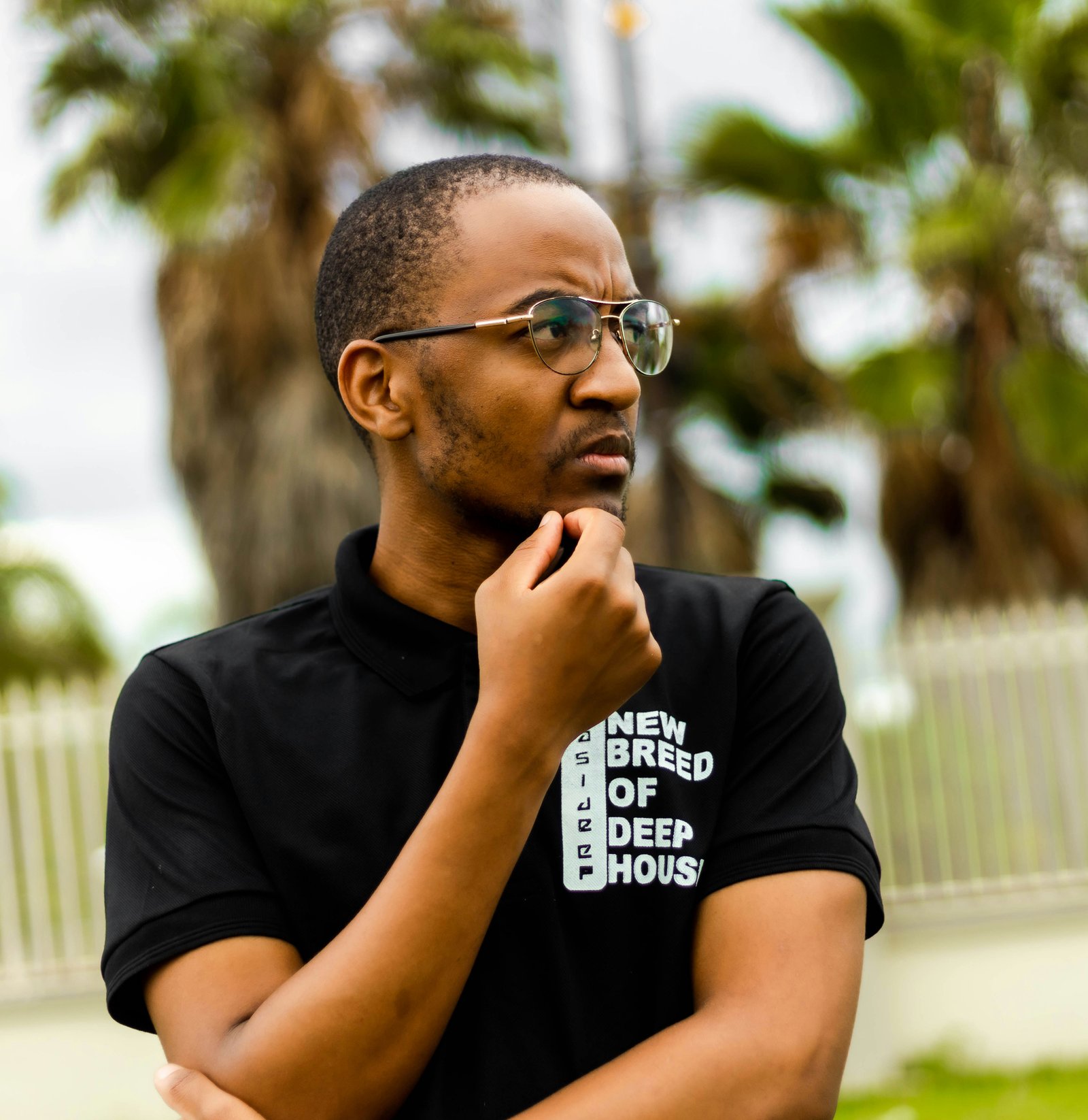 A man wearing a black shirt and glasses